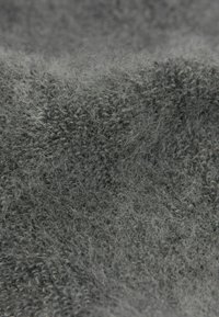 Šedá látka s měkkou, plyšovou texturou, jemnými vlákny a mírně nerovným povrchem, zobrazující různé odstíny šedé.