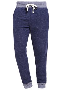 Navyblaue Jogginghosen mit grauem elastischem Bund, verstellbarem Kordelzug, gerippten Bündchen und Fronttaschen. Glatte Textur mit dezenten Sprenkeln.