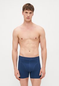 Navy blue boxer briefs with a ribbed elastic waistband featuring the text "BJÖRN BORG." Made of smooth, stretchy fabric with a fitted design.