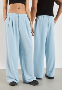 YOURTURN by Zalando - UNISEX - Trousers - light blue Thumbnail Image 1