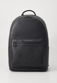 Black backpack with a smooth texture and a geometric patterned front pocket. Features a top handle and dual zippers. Minimalistic design.