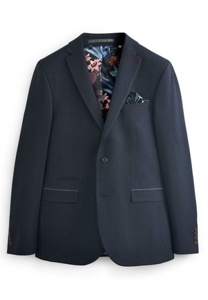 Blazer blu navy in tessuto a trama, chiusura con un bottone e due tasche frontali. Fodera con motivo floreale e un fazzoletto da taschino come accentuazione.