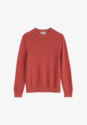 Megztinis koralo spalvos, megztas su tekstūruotu raštu, apvaliu iškirpimu bei banguotais rankogaliais ir apačia. Įprastas fasonas, minkšta medžiaga.