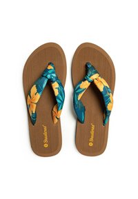 Chanclas con suela de goma marrón y tiras de tela floral azul con flores amarillas, anudadas en el centro. Superficie texturizada.