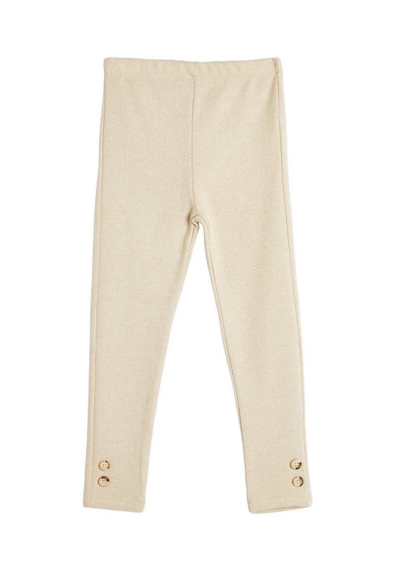 Leggings de patrón de espiga en color beige con un ajuste ceñido, que cuentan con una cinturilla segura y dos botones dorados cerca del dobladillo.