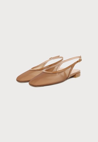 Pair of light brown slingback flat shoes with pointed toes and small block heels on a white background.