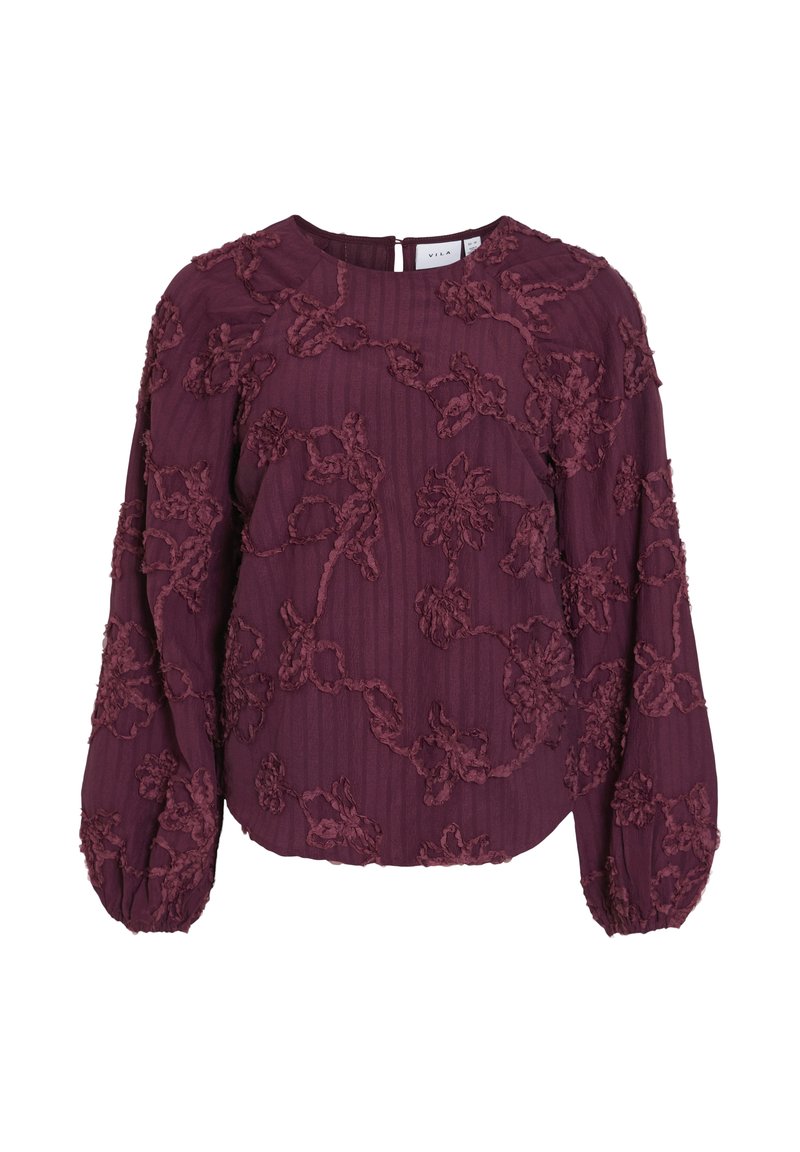 Burgundy blus med texturerad blommig broderi, ballongärmar, ribbat tyg och nyckelhålsstängning bak.