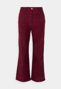 Burgundy corduroy flared trousers with a textured finish, two front pockets, and a button closure at the waist.