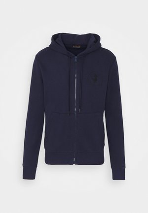 Sweat à capuche bleu marine zippé avec poches avant, capuche avec cordon, poignets et ourlet côtelés, et logo discret de canard sur la poitrine.