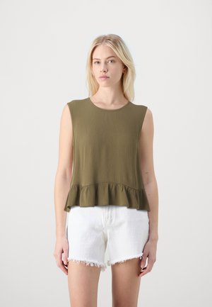 Olive green sleeveless top with a textured finish, featuring a peplum hem. Paired with white frayed denim shorts for contrast.