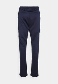 Marineblauwe sportbroek met elastische tailleband, taps toelopend design en contrasterende stiksels langs de zijkanten. Gemaakt van een zachte, rekbare stof.