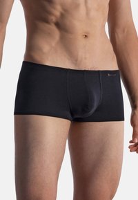 Black boxer briefs made of soft fabric; features a fitted design with a comfortable waistband and minimalistic style.