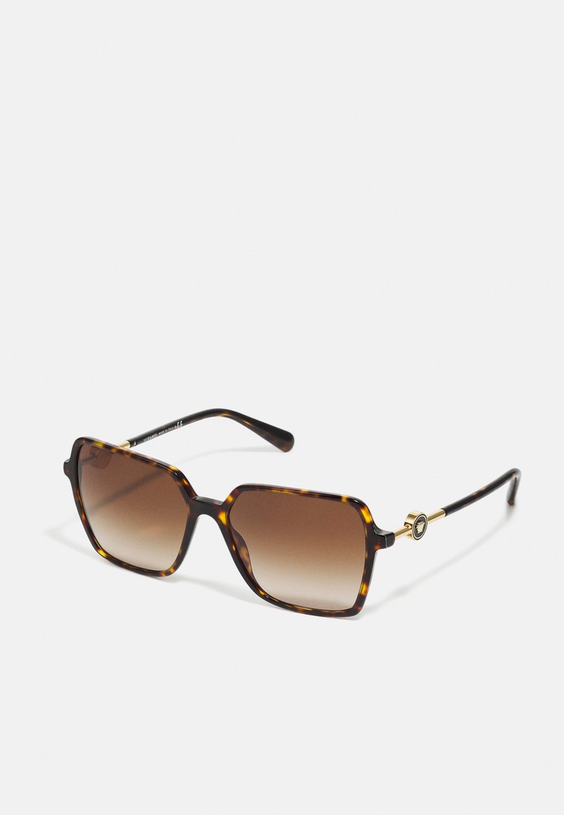 Óculos de sol tartaruga com formato quadrado, lentes castanhas em gradação e acabamento dourado na haste, apresentando um acabamento brilhante e elegante.