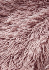 Soft, shaggy fabric in light mauve with long, textured fibers, creating a plush appearance and inviting tactile quality.