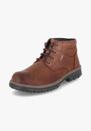 Bottes en cuir marron à la cheville avec bout rond, conçu avec un laçage, semelle en caoutchouc texturée et détails de couture renforcés. Membrane imperméable incluse.