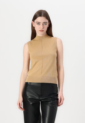 Sleeveless, high-neck tan knit top with a ribbed hem and subtle texture; paired with black leather pants.