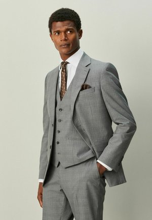 Gray three-piece suit with a subtle plaid pattern, featuring a notch lapel, four-button vest, and brown polka dot tie. Pocket square included.