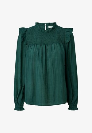 Tumes roheline pluus, mis on valmistatud tekstureeritud kangast, kõrge smockitud kaelusega, ruffledega õlavarre detailiga ning pikkade varrukatega, millel on kogutud mansetid.