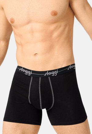 Boxer briefs neri in cotone con un elastico grigio che presenta il marchio "Sloggi", progettati con una vestibilità aderente e cuciture rinforzate.