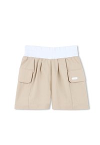 Pantalones cortos de algodón beige con una cinturilla elástica blanca, que cuentan con dos bolsillos laterales y un diseño plisado. Textura suave, estilo casual.
