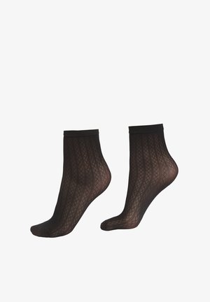 Schwarze Knöchelsocken mit einem geometrischen Muster, geripptem Muster und einem festen schwarzen Bund. Hergestellt aus einem transparenten, elastischen Material.
