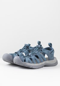 Blue, breathable outdoor sandals with woven fabric upper, elastic laces, and a gray rubber sole for traction and durability.