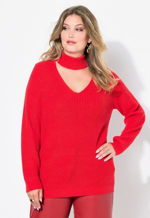Maglione rosso a coste con scollo a V e colletto choker. Maniche lunghe, vestibilità ampia, tessuto a maglia testurizzato e orlo che copre i fianchi.