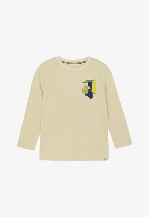 Long-sleeve light yellow cotton t-shirt featuring a multicolored graphic print on the chest and a striped neckline detail.