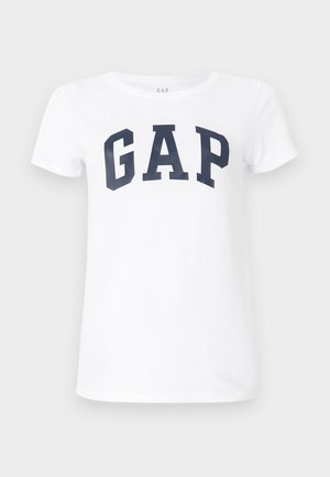 Valge lühikeste varrukatega T-särk, mille rinnal on suur tumelilla "GAP" logo.