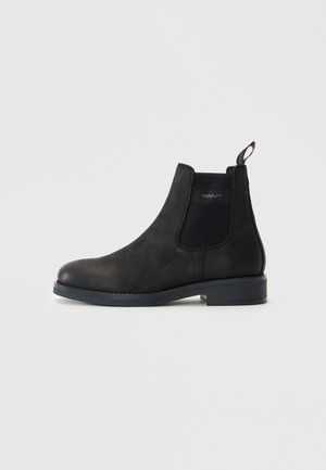 Black leather Chelsea boot with elastic side panels, low heel, pull tab at back, and "GANT" logo on side panel.