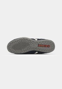 Navy sneaker with a textured fabric upper, white side stripes, and a gray rubber outsole featuring a dotted pattern and "Geox" logo.