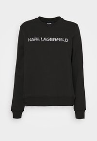 Sudadera negra con cuello redondo, puños y dobladillo acanalados; presenta el texto "KARL LAGERFELD" en letras blancas texturizadas en el frente.
