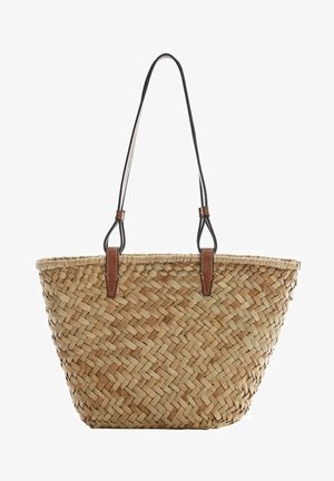 Woven straw tote bag with natural beige tones, featuring black leather shoulder straps and brown leather accents. Open top design.