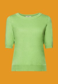 Haut en maille manches courtes vert clair avec col rond et poignets côtelés, présenté sur un fond orange.