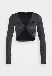 Svart och silver långärmad crop top med vriden frontdesign, ribbad textur och subtila skimrande detaljer genom hela tyget.