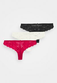 Ensemble de lingerie en dentelle avec string, disponible en noir, blanc et rouge. Présente des motifs floraux et des bords festonnés. Tissu doux avec un ajustement extensible.
