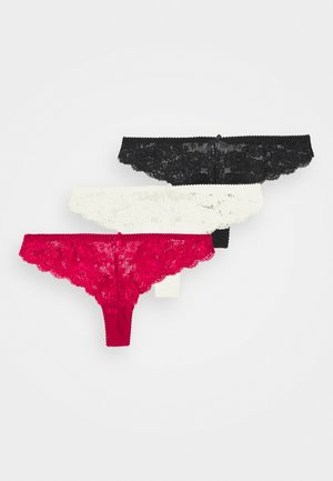Ensemble de lingerie en dentelle avec string, disponible en noir, blanc et rouge. Présente des motifs floraux et des bords festonnés. Tissu doux avec un ajustement extensible.