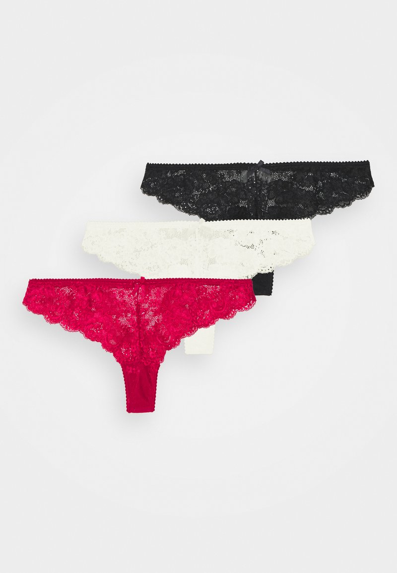Ensemble de lingerie en dentelle avec string, disponible en noir, blanc et rouge. Présente des motifs floraux et des bords festonnés. Tissu doux avec un ajustement extensible.