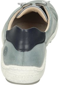 Light blue suede shoe with a navy leather heel accent, featuring a textured white sole and neutral lining, designed for comfort and style.
