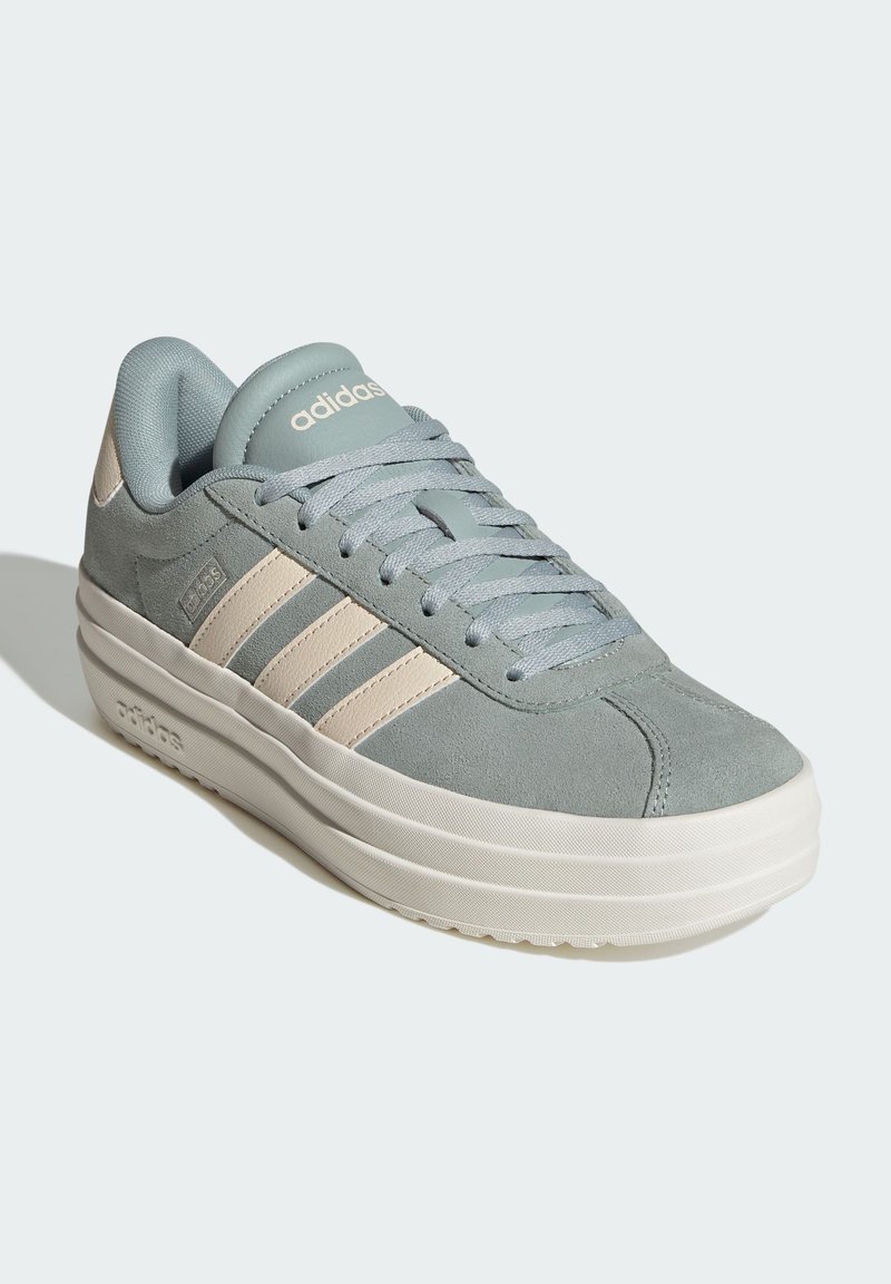 Light blue suede sneakers with cream accents and three white stripes; thick white rubber sole; cushioned tongue and laces.