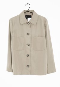 Beige button-up shirt with a pointed collar, two front pockets, and large buttons. Made from smooth fabric with a relaxed fit.