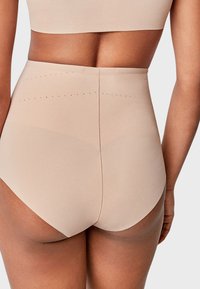 Beige visoke gaćice bez šavova s glatkom tkaninom, sa suptilnim točkicama uz pojas.