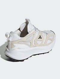 Scarpa atletica bianca con accenti in rete e suede, dotata di una suola ammortizzata, sovrapposizioni testurizzate e una linguetta sul tallone.