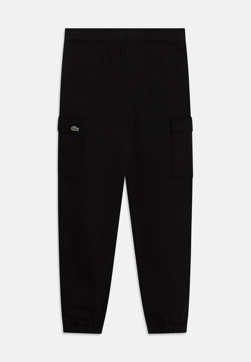 Pantalons de survêtement noirs en tissu doux avec une taille élastique, jambes fuselées et deux poches cargo latérales. Présente un petit patch logo.