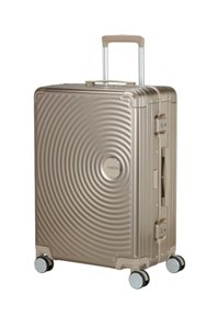 Valigia rigida di colore beige metallico con design a onde circolari, manico telescopico, manico laterale e quattro ruote multidirezionali.