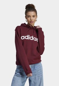 adidas Sportswear ESSENTIALS LINEAR - Mikina s kapucňou - shadow red   white