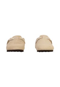 Zapatos de ante beige tipo slip-on con punta redondeada, que cuentan con dos correas ajustables y una suela de goma negra texturizada.