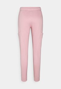 Rosa sweatpants med elastisk midja, sidofickor, avsmalnande ben och mjuk, slät textur. Designade för komfort och rörelsefrihet.