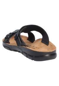 Black flip-flop sandal with adjustable strap, cork footbed, rubber outsole, and soft texture on the straps, featuring a minimalist design.