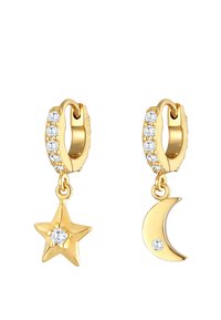 Zlatne obruče za uši s redom malih prozirnih rhinestones i visećim čarima: zvijezda i mjesečeva krošnja, svaka ukrašena rhinestonom.